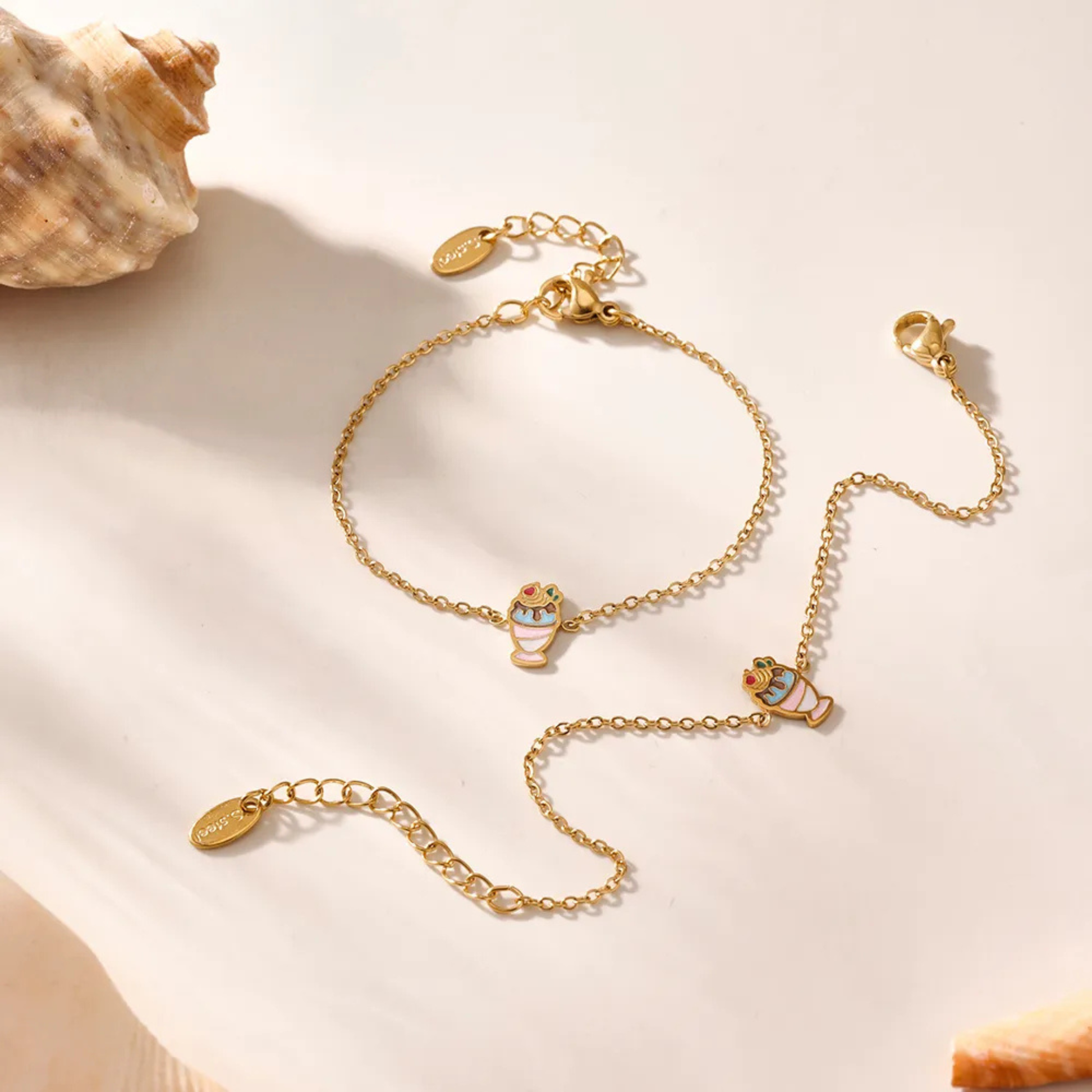 Gold bracelet with decorative elements on a beige background