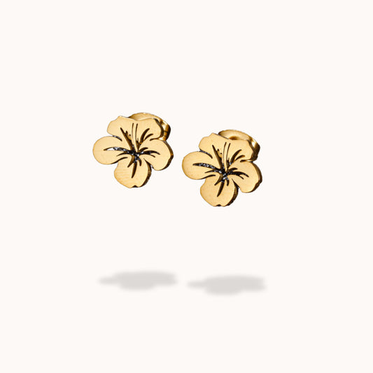 Gold flower-shaped earrings on a white background