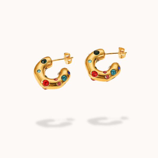 Gold hoop earrings with colorful gemstones on a white background
