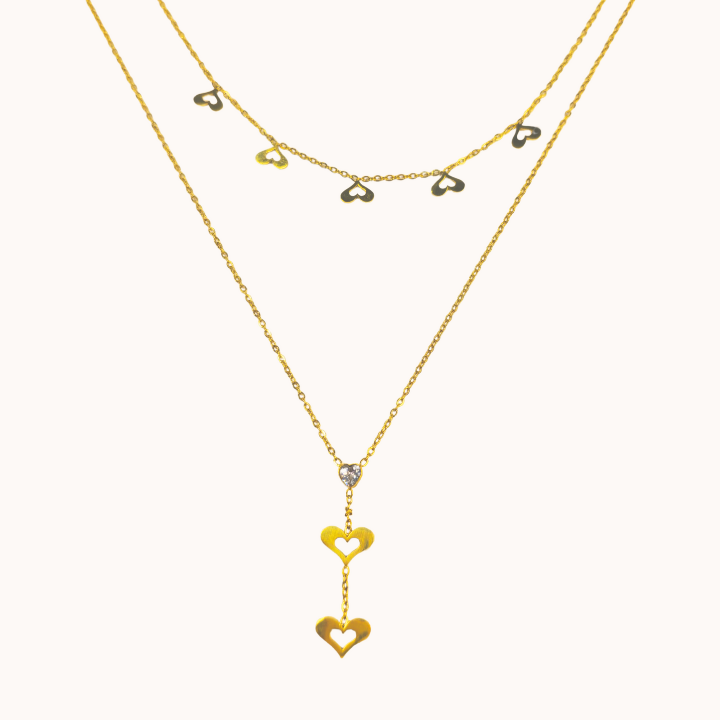 Gold necklaces with heart-shaped pendants on a white background