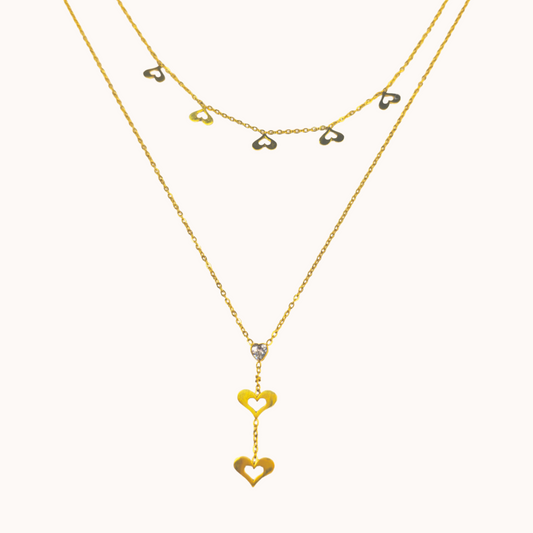 Gold necklaces with heart-shaped pendants on a white background