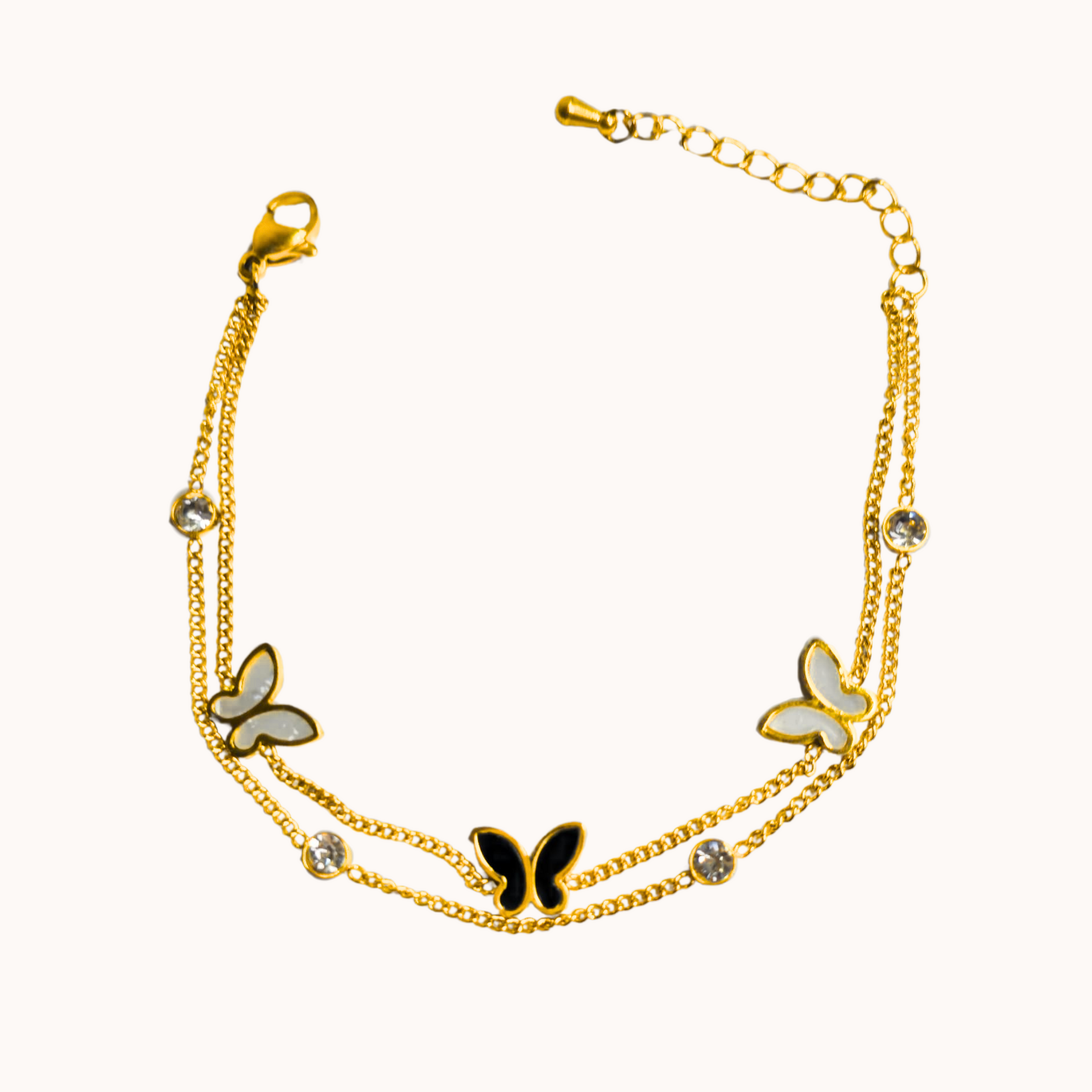 Gold bracelet with butterfly charms on a white background