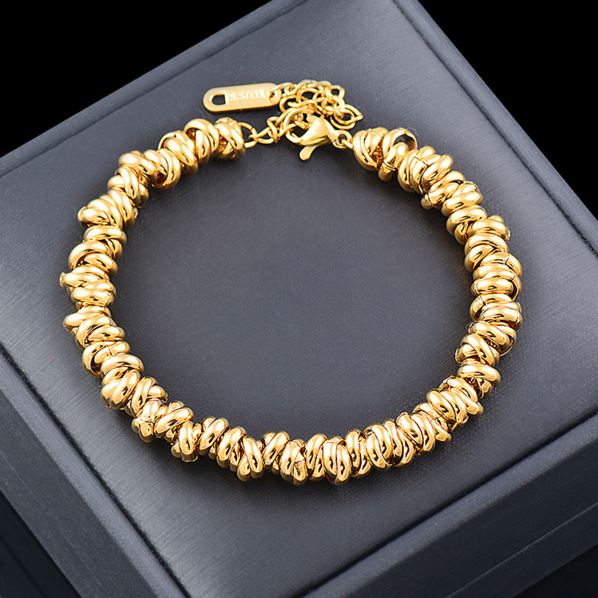 Gold bracelet on a dark gray surface