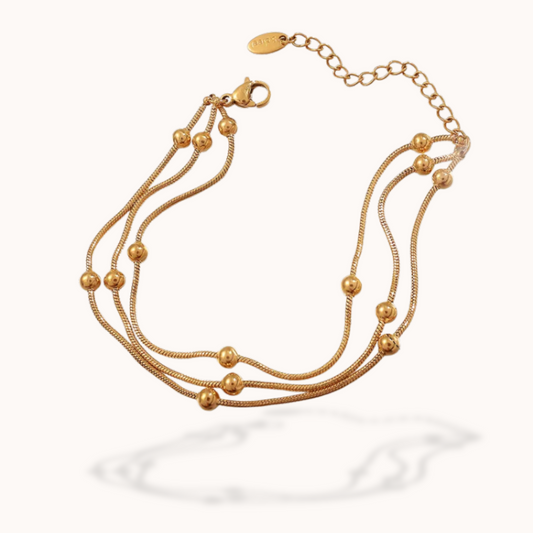 Gold bracelet with multiple strands on a white background