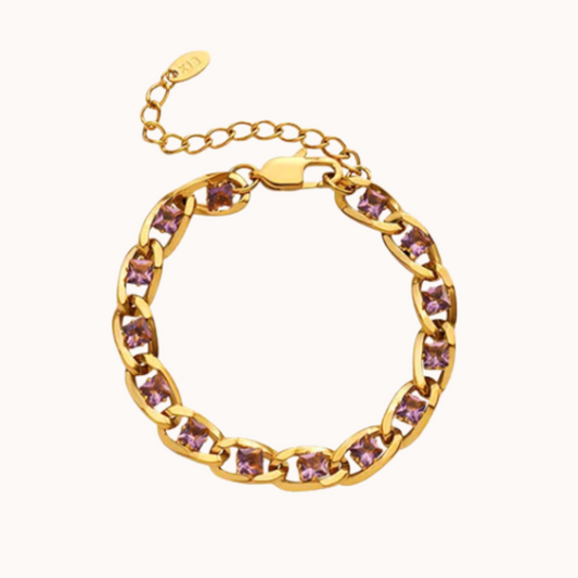 Gold bracelet with purple gemstones on a white background