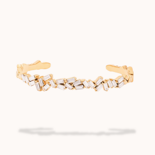 Gold bracelet with diamond accents on a white background