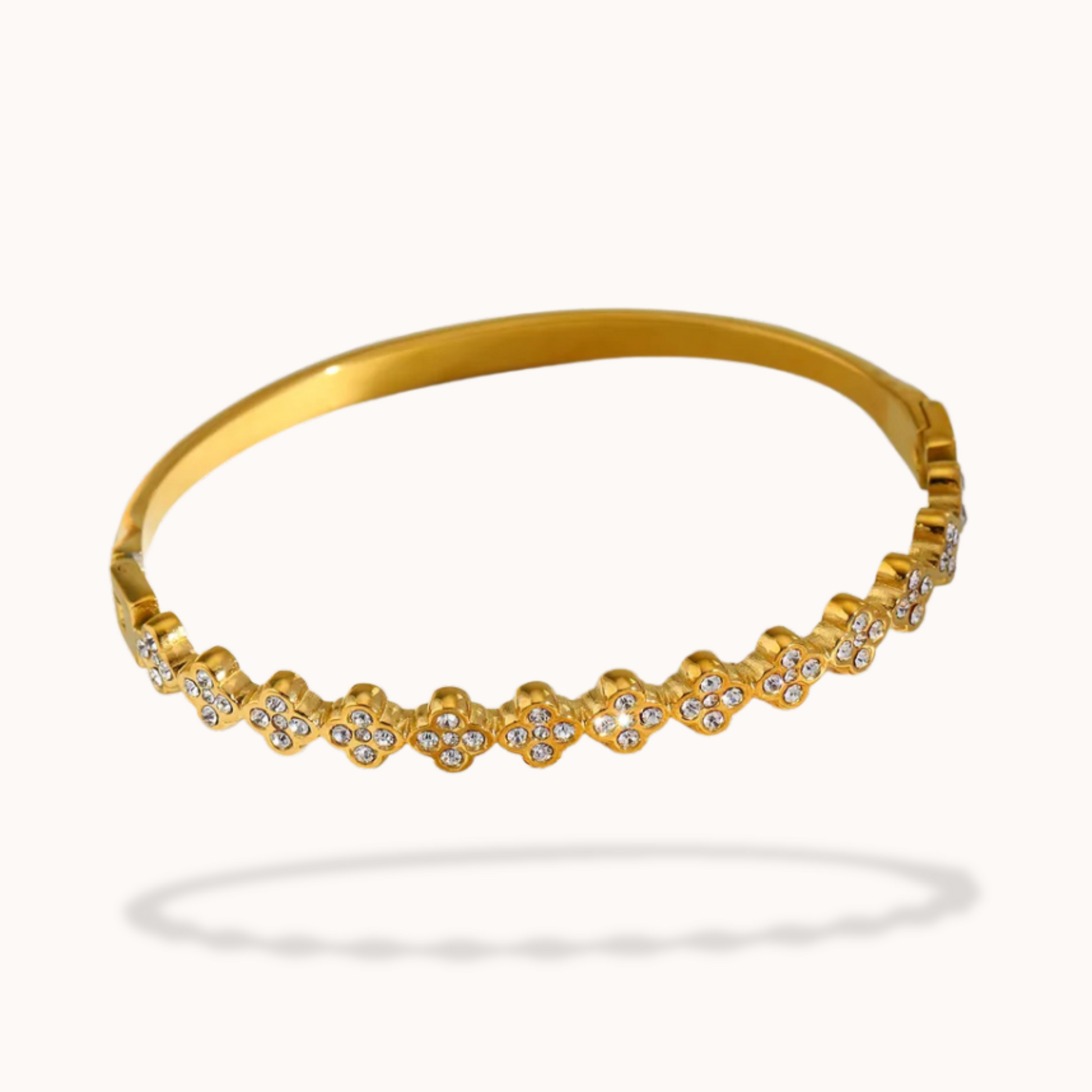 Gold bracelet with small diamonds on a white background