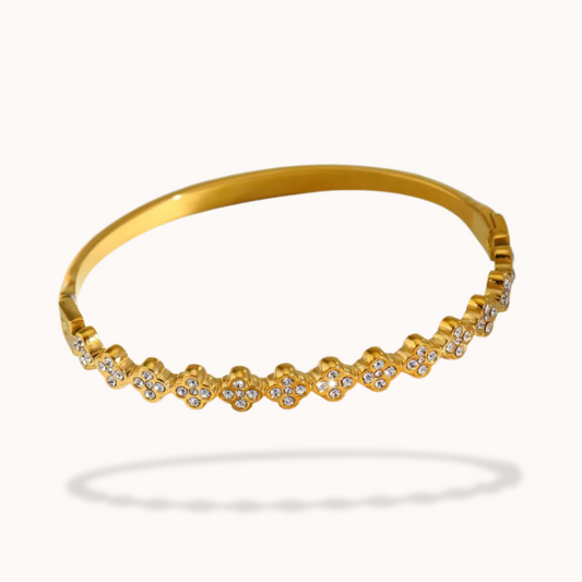 Gold bracelet with small diamonds on a white background