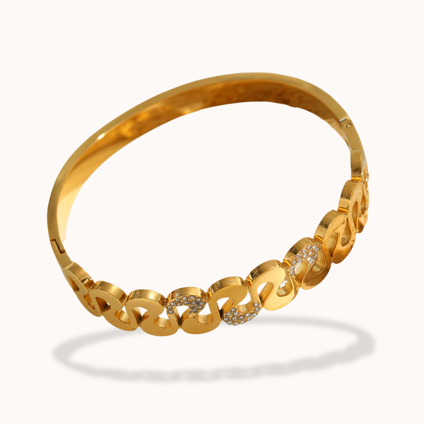 Gold bracelet with interlocking links on a white background