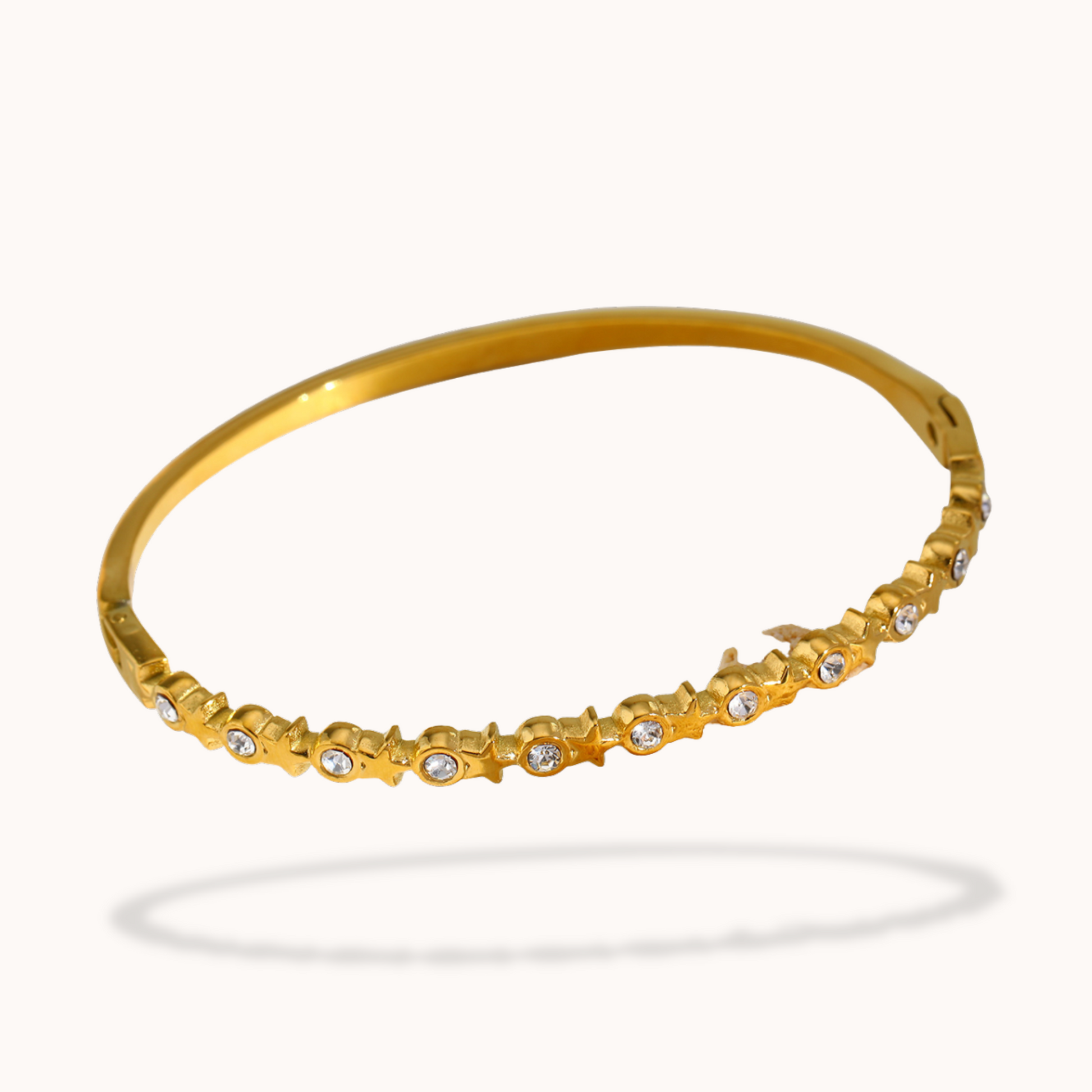 Gold bracelet with small diamonds on a white background