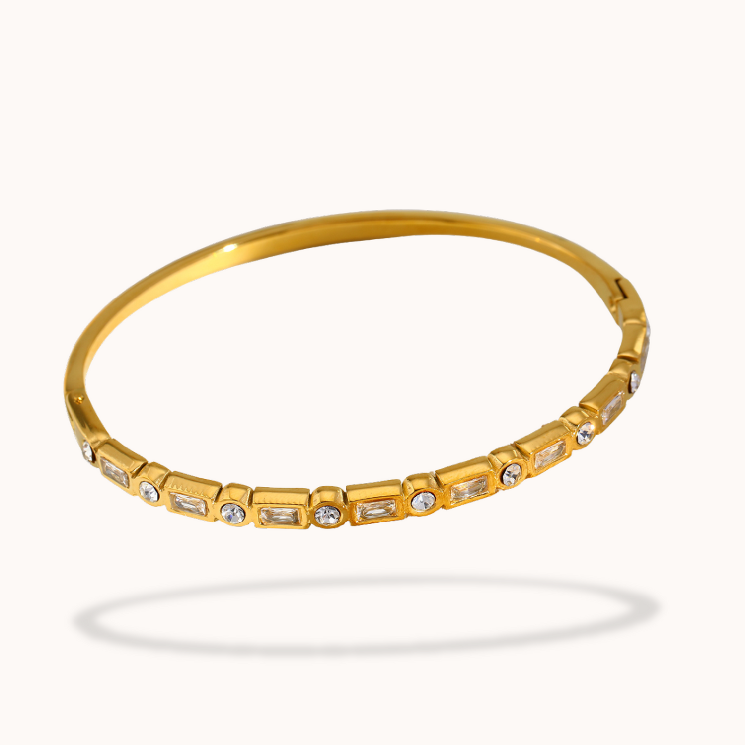 Gold bracelet with embedded stones on a white background