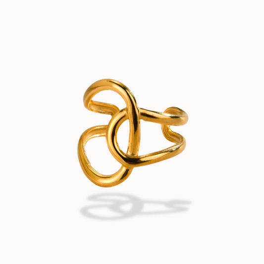 Gold ring with a knot design on a white background
