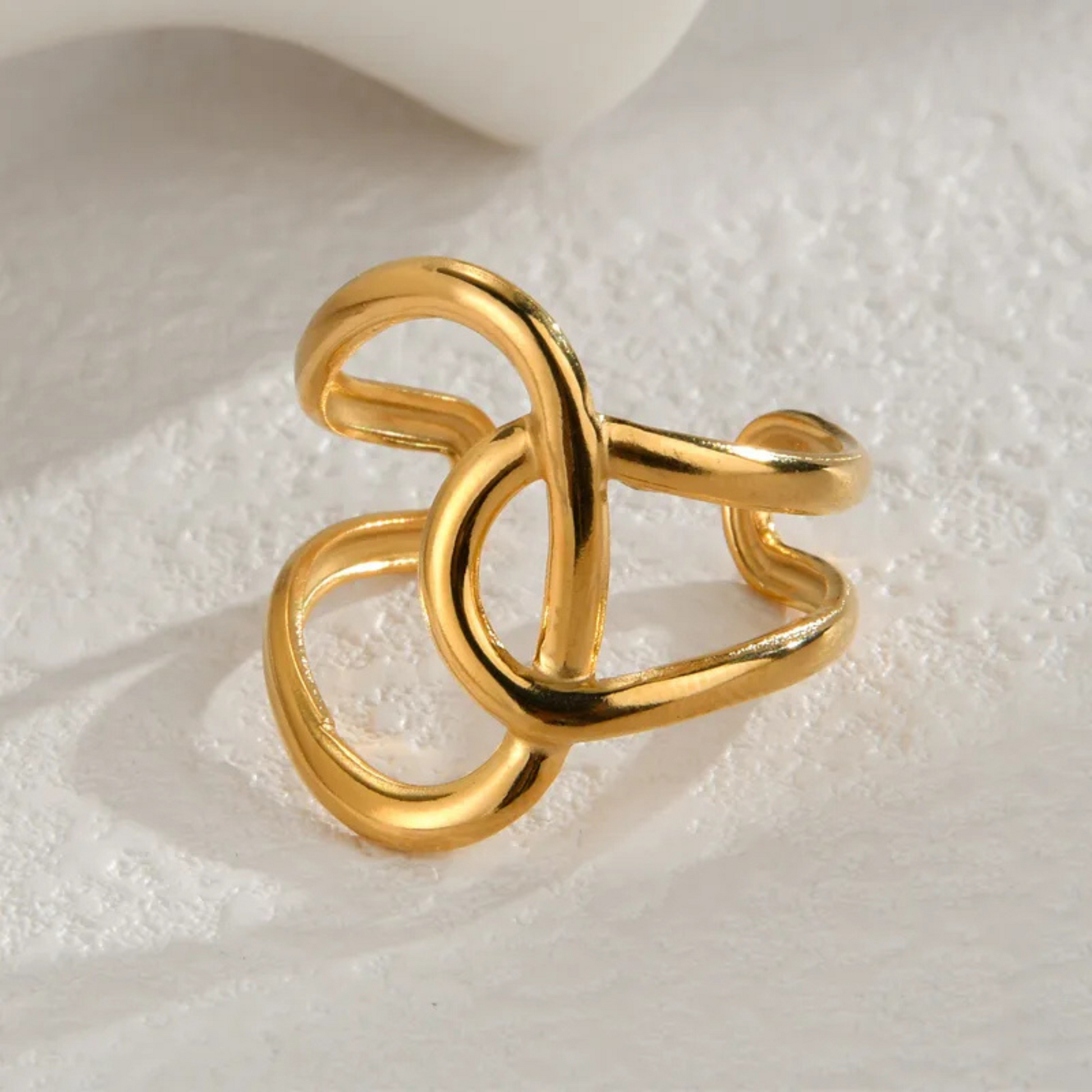 Gold ring with a unique design on a light background