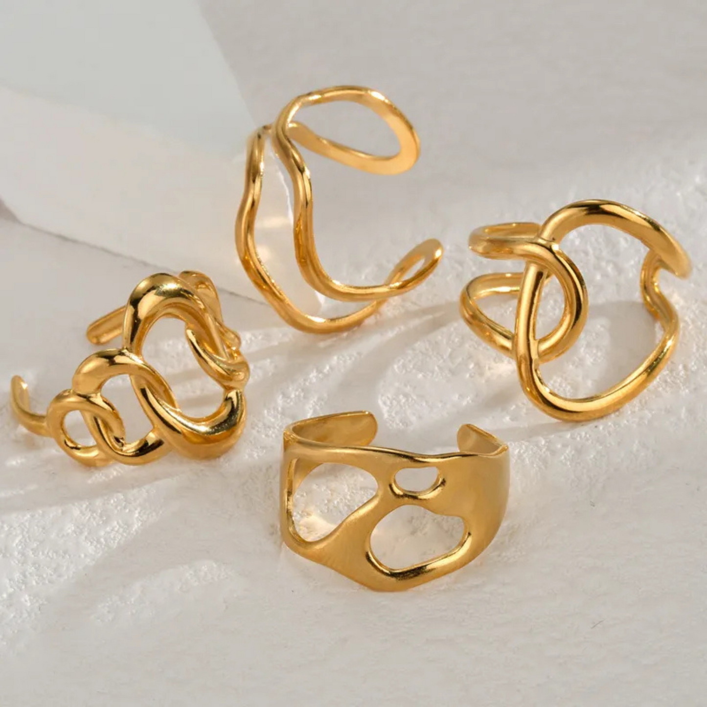 Set of gold rings on a textured white surface
