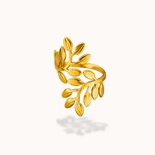 Gold leaf-shaped ring on a white background
