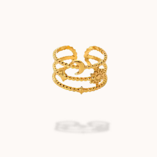 Gold ring with intricate design on a white background