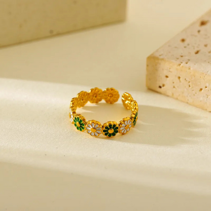 Gold ring with floral designs on a beige background