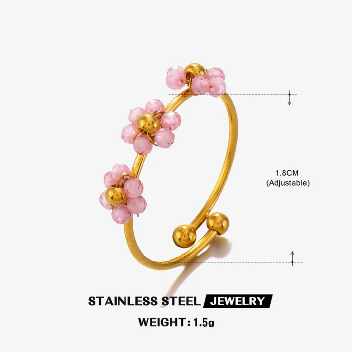 Gold ring with pink beads on a white background