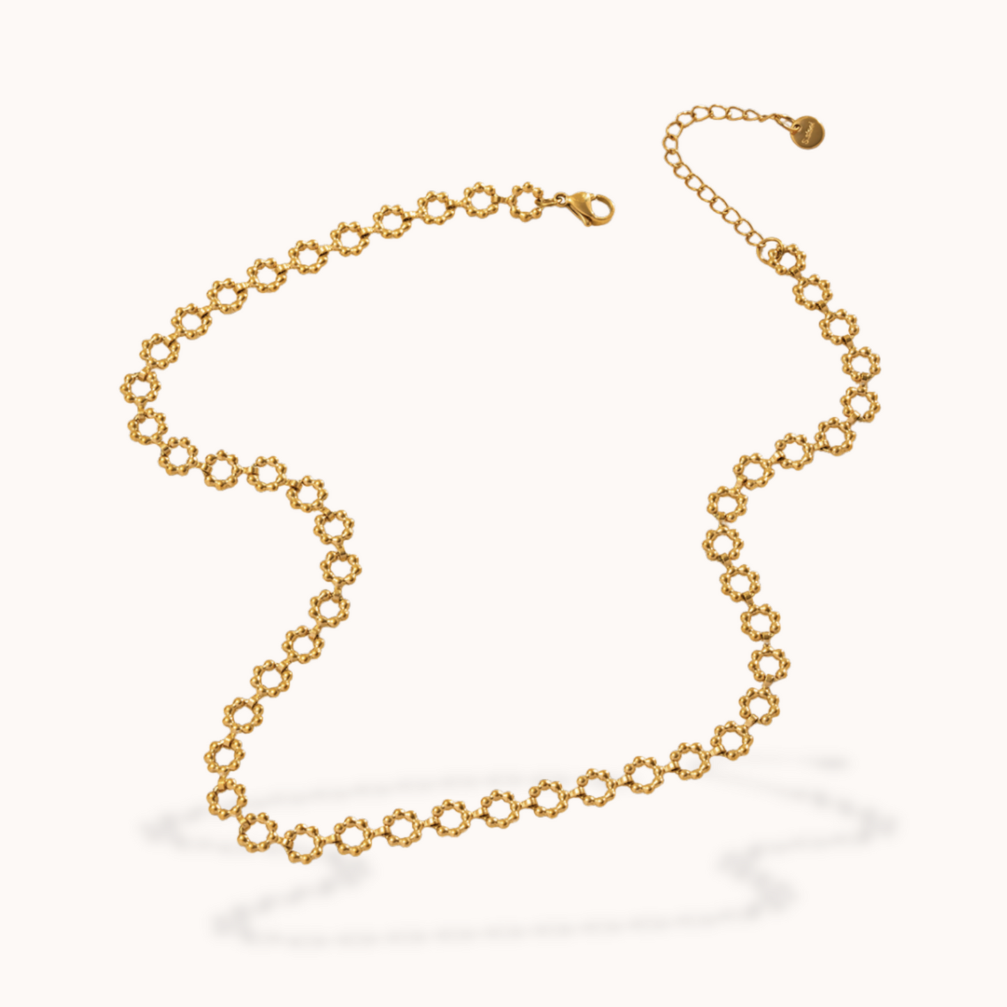 Gold flower chain necklace on a white background