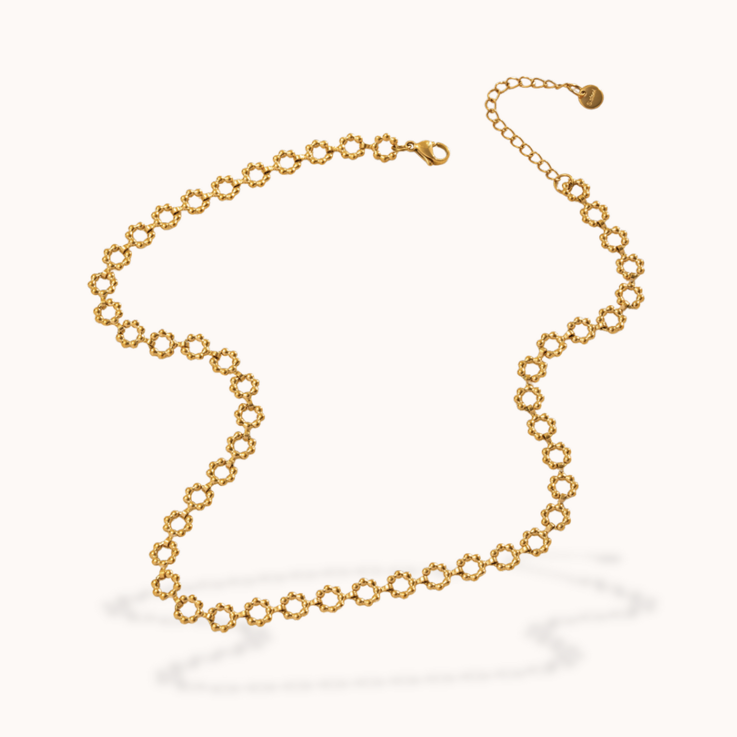 Gold flower chain necklace on a white background