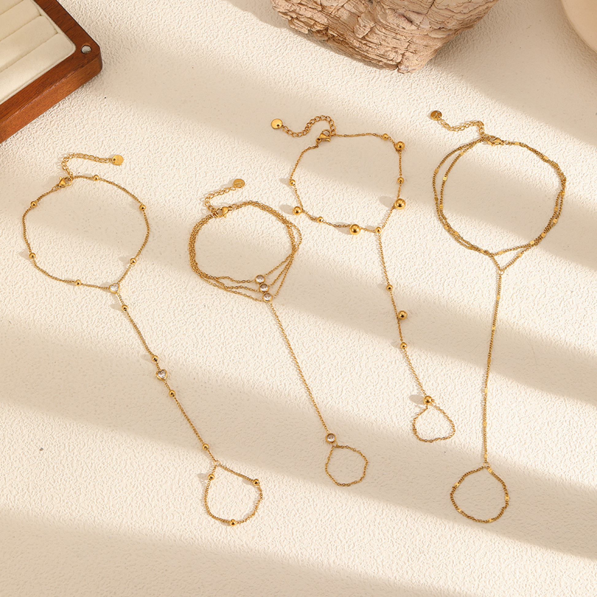 Gold Ring Bracelet on a textured beige surface