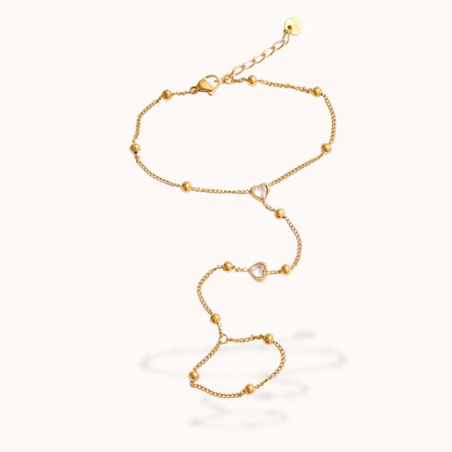 Gold ring bracelet with heart-shaped links on a white background