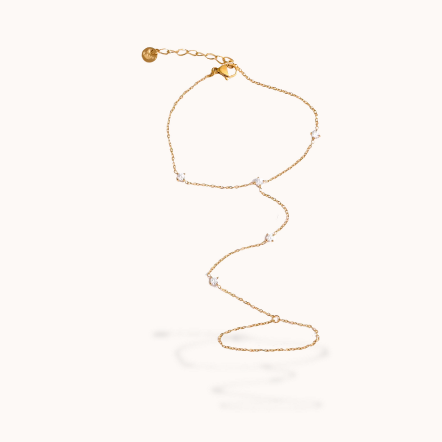 Gold ring bracelet with small beads on a white background