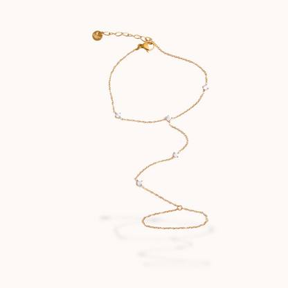 Gold ring bracelet with small beads on a white background