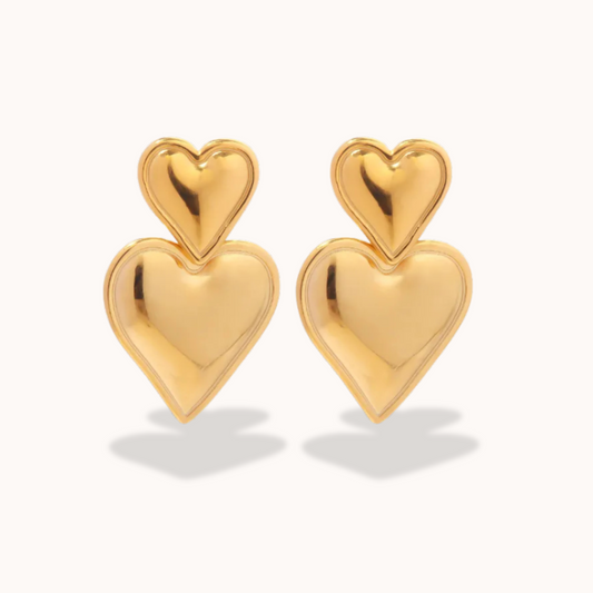 Gold heart-shaped earrings on a white background