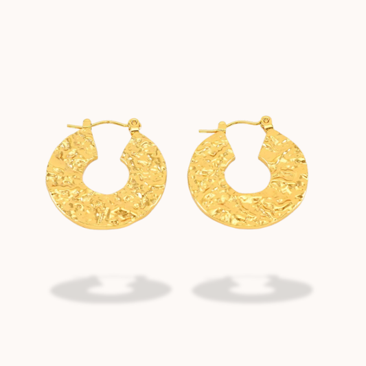 gold hoop earrings in light grey background