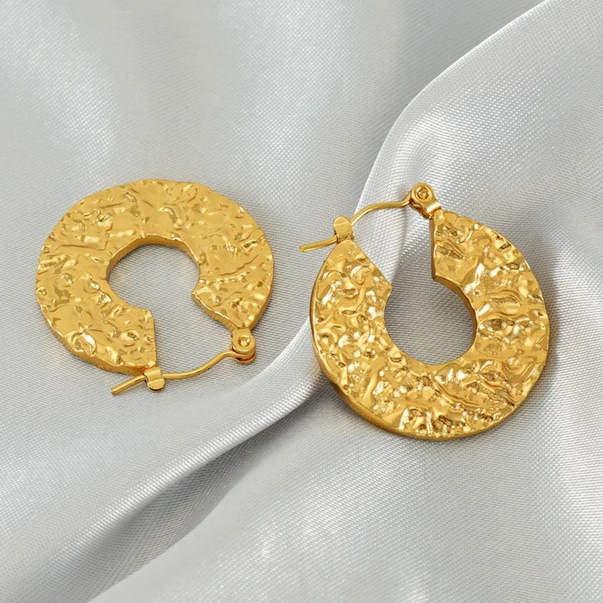 gold hoop earrings in grey background