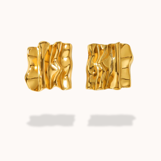 Pair of square gold earrings on a white background