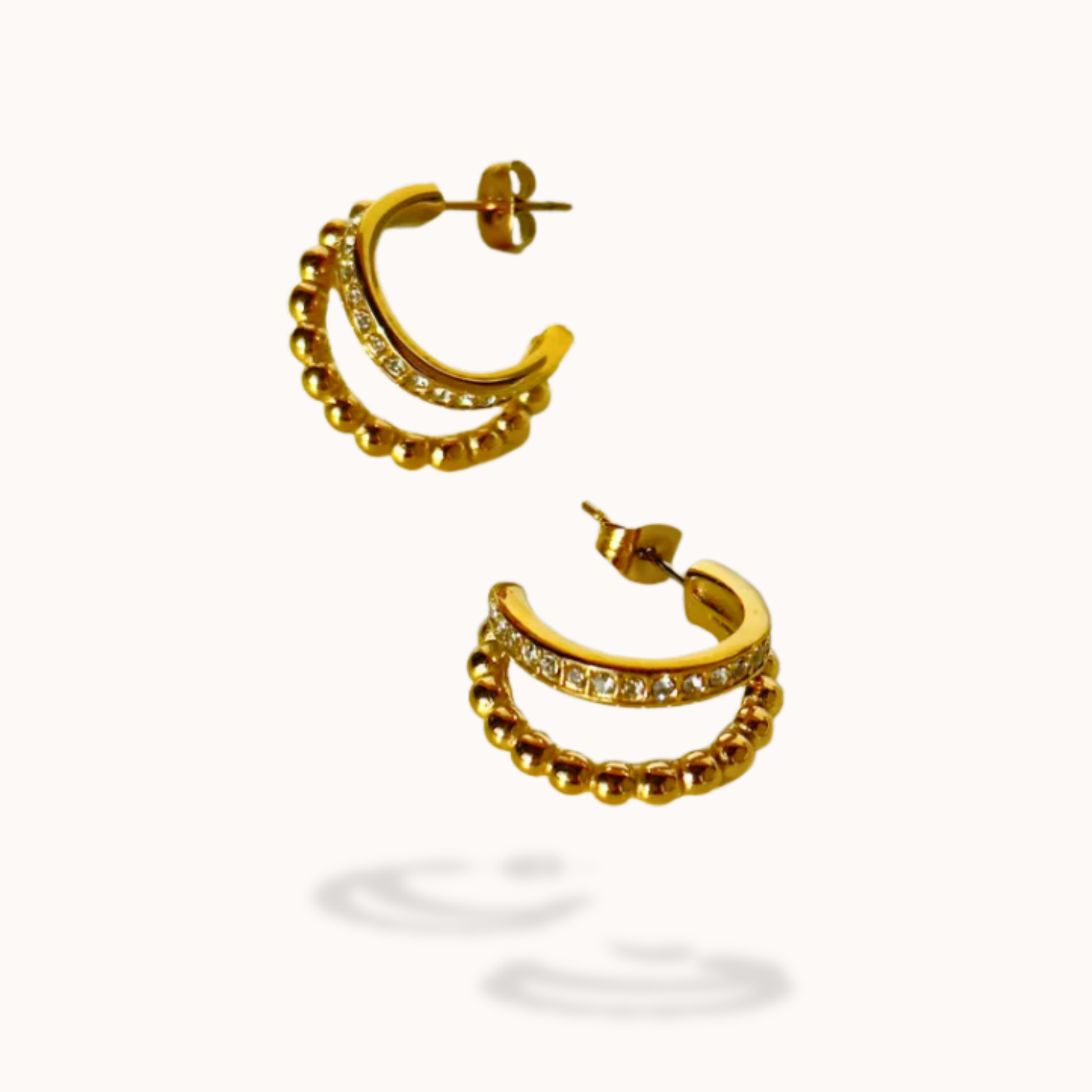 Gold hoop earrings with embedded stones on a white background