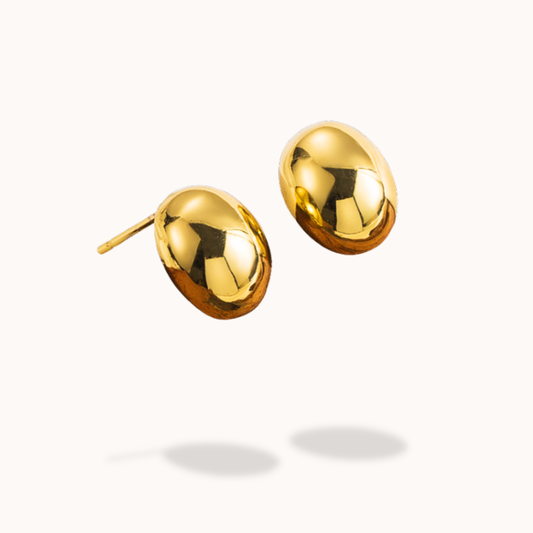 Pair of gold earrings on a white background