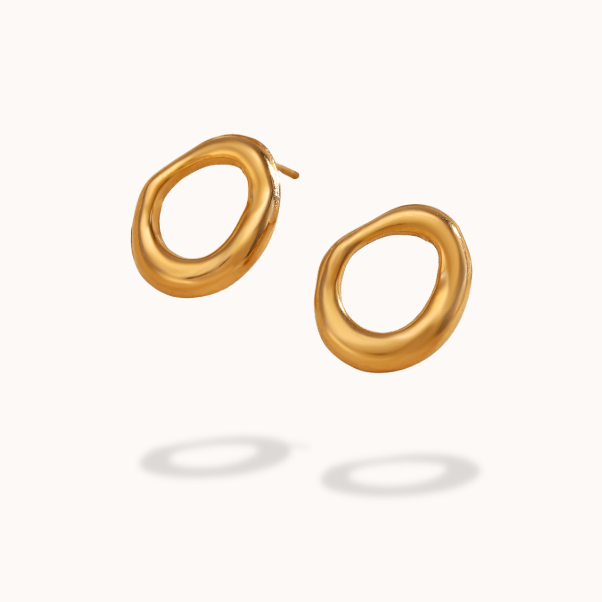 Gold stud earrings on a white background