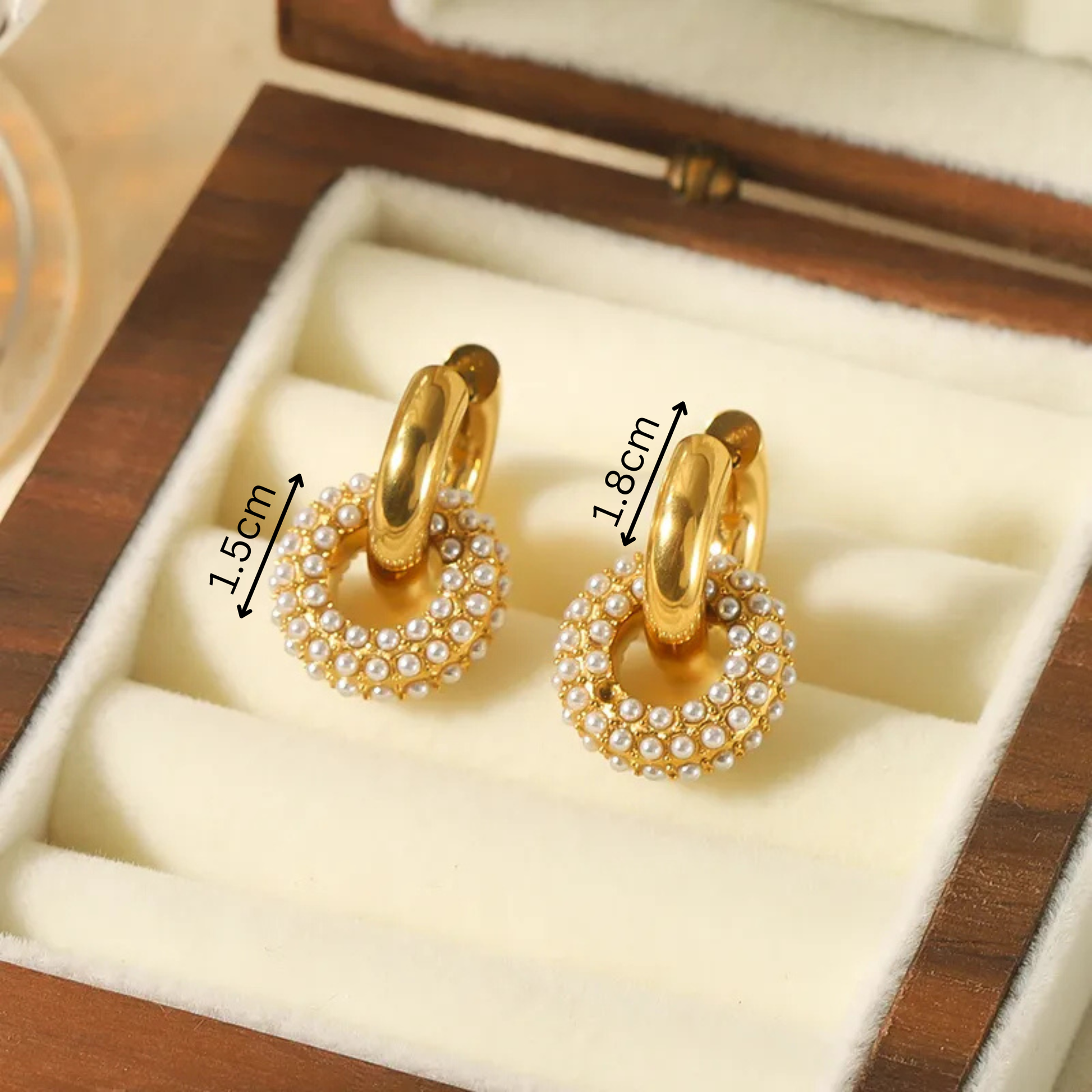 Gold hoop earrings with pearl accents in a wooden box, showing measurements.