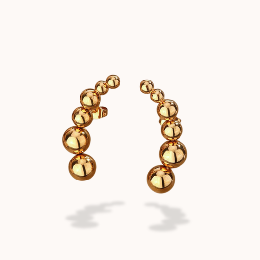 Gold stud earrings with round beads on a white background