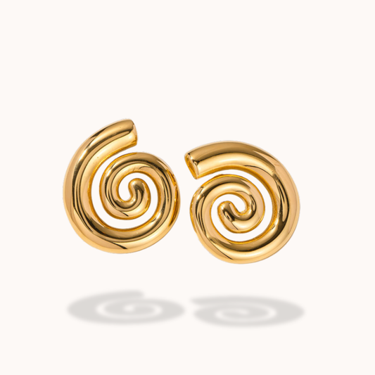 Gold spiral earrings on a white background