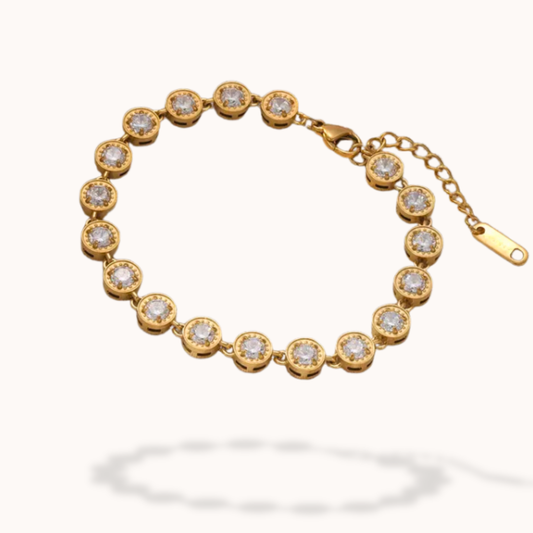 Gold bracelet with diamond accents on a white background