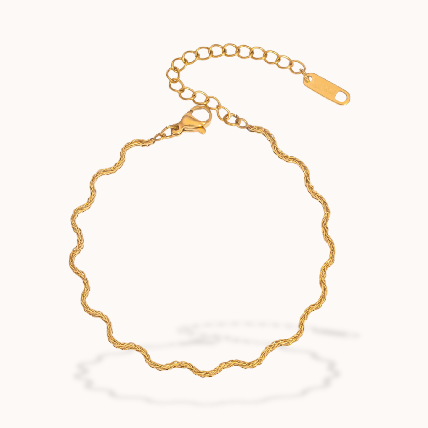 Gold wavy bracelet on a white background