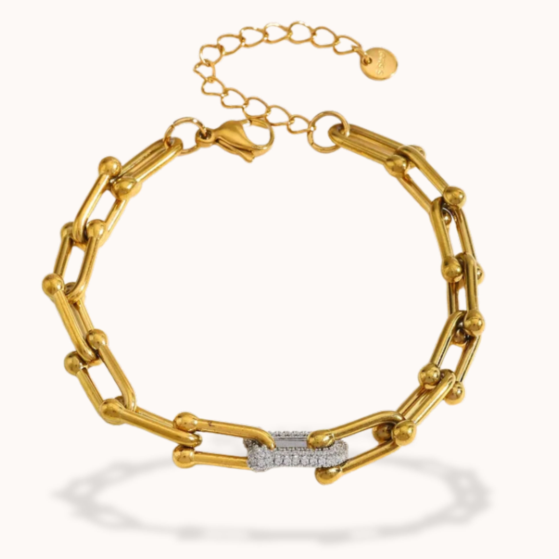 Gold chain bracelet with a diamond clasp on a white background