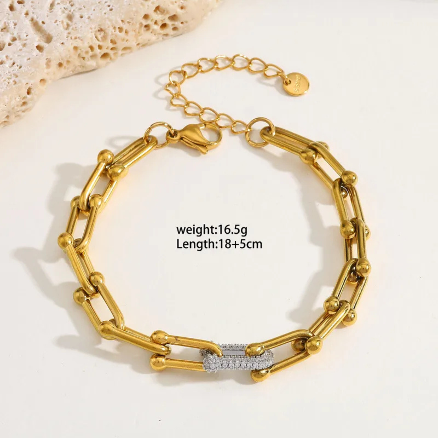 Gold bracelet with chain design on a light background