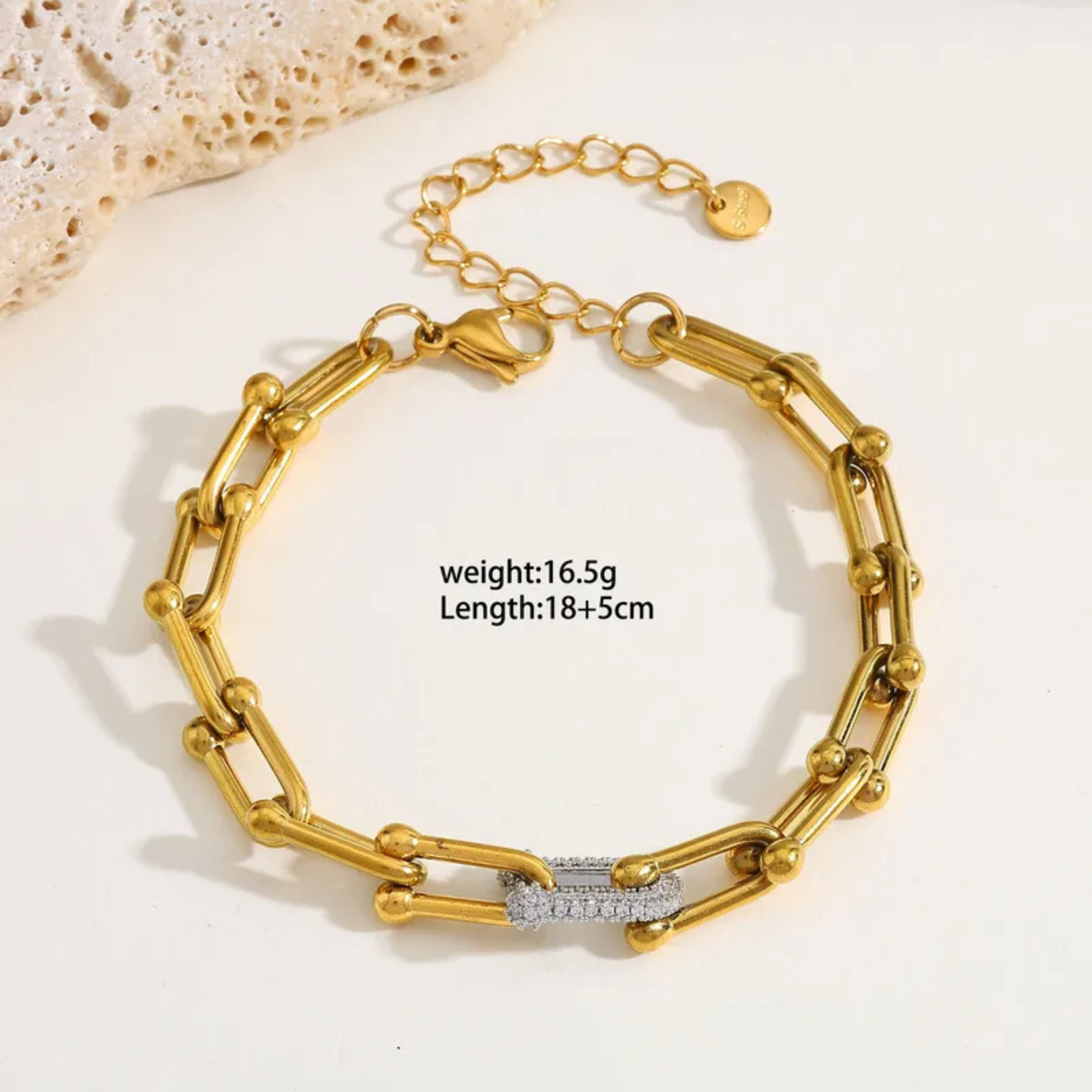 Gold bracelet with chain design on a light background