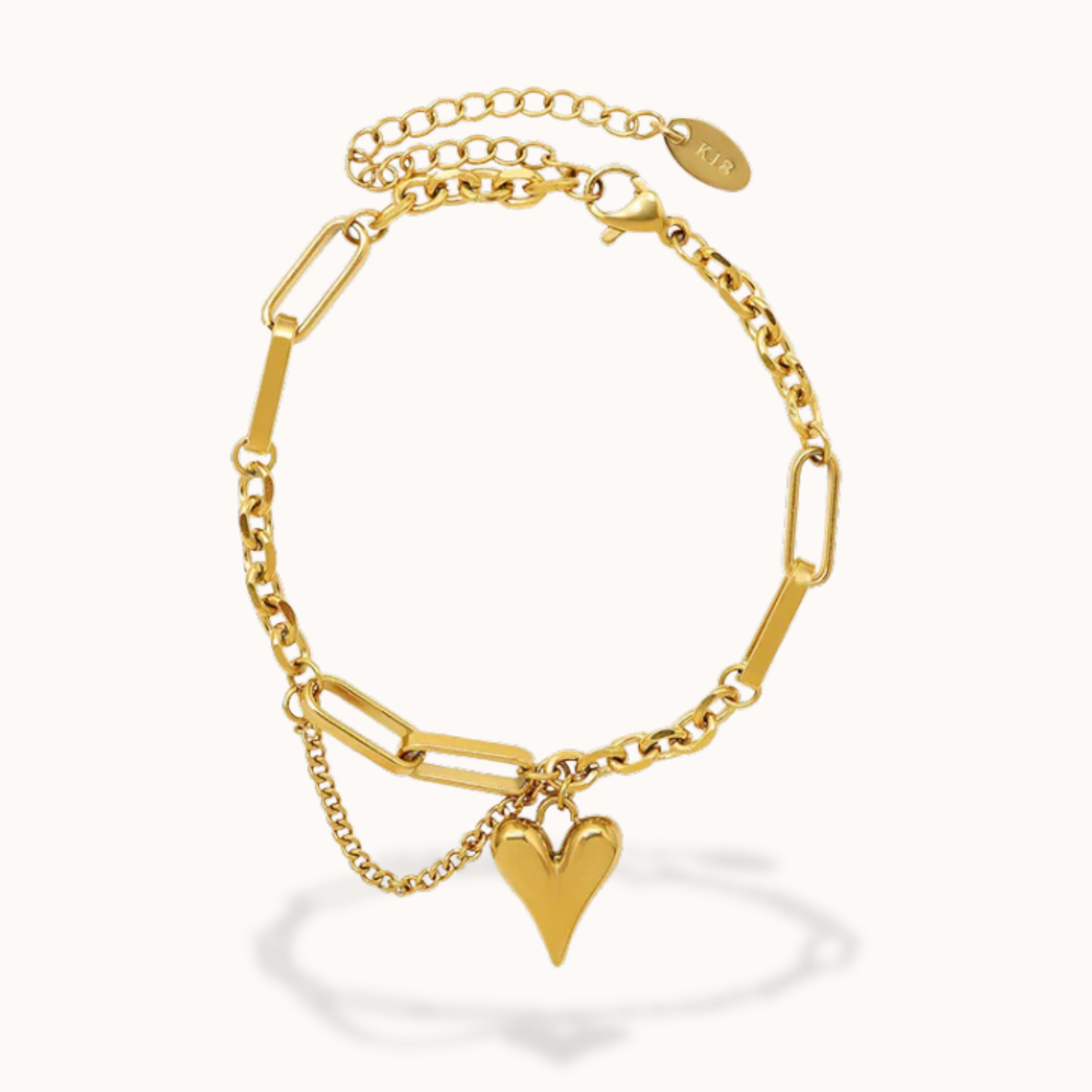 Gold bracelet with a heart charm on a white background