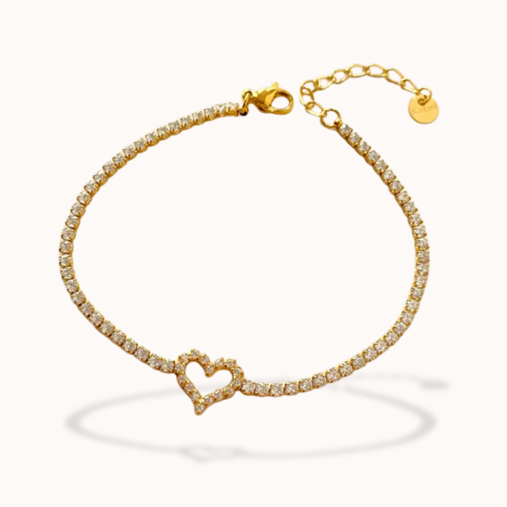 Gold bracelet with a heart-shaped clasp on a white background