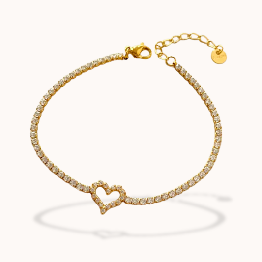 Gold bracelet with a heart-shaped clasp on a white background