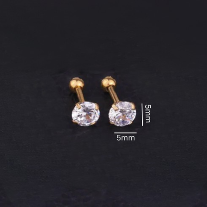 Gold stud earrings with clear gemstones on a dark background, showing measurements.