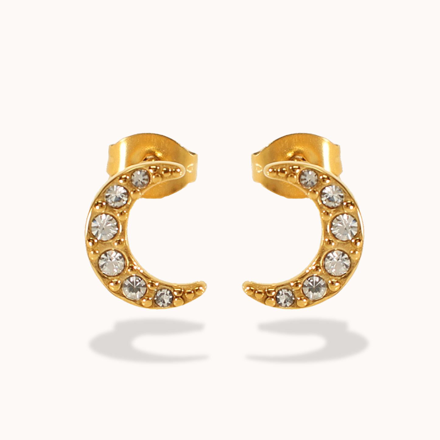 Gold stud earrings with embedded crystals on a white background