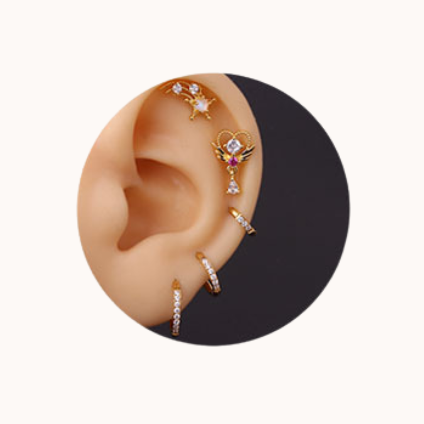 Close-up of an ear with multiple gold and diamond-studded earrings.