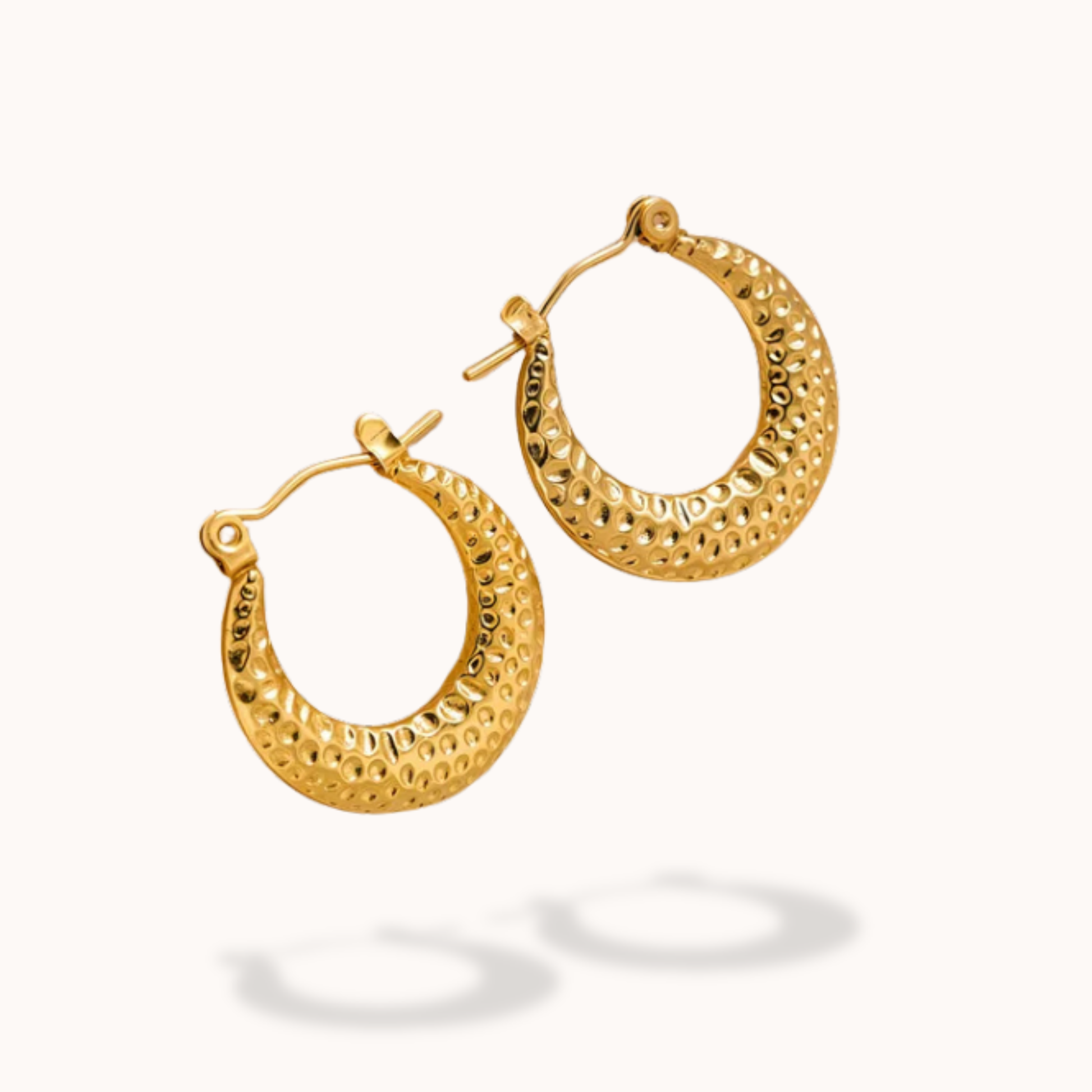 Gold hoop earrings on a white background